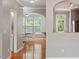 Open concept featuring hardwood floors with arched entry into the dining area with abundant natural light at 5003 Celtic Ct, Raleigh, NC 27612