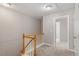 Upstairs hallway featuring neutral walls and carpet and white trim work at 5003 Celtic Ct, Raleigh, NC 27612