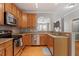 Updated kitchen with stainless steel appliances, ample counter space, and natural wood cabinets at 5003 Celtic Ct, Raleigh, NC 27612