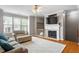 Inviting living room features a cozy fireplace, hardwood floors, and plenty of natural light at 5003 Celtic Ct, Raleigh, NC 27612