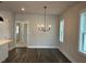 Spacious dining room with wood floors and a modern chandelier at 508 Yeowell Dr, Chapel Hill, NC 27514