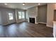 Bright living room featuring a fireplace, neutral paint, and wood floors at 508 Yeowell Dr, Chapel Hill, NC 27514