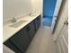 Stylish bathroom with a double vanity, modern faucets, gray cabinets, and neutral tile flooring at 510 Yeowell Dr, Chapel Hill, NC 27514