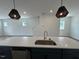 Spacious kitchen with white cabinets, a gray island, and modern pendant lighting at 510 Yeowell Dr, Chapel Hill, NC 27514