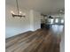 Bright, open-concept living space with wood floors, white cabinets, kitchen island, and modern lighting at 510 Yeowell Dr, Chapel Hill, NC 27514