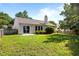 Backyard featuring a well-maintained lawn, patio, and lush landscaping at 608 Kinship Ln, Apex, NC 27502