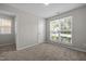 Light filled bedroom with large window, carpet and a view of another room at 608 Kinship Ln, Apex, NC 27502