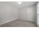 Cozy bedroom with neutral carpet, white door, and a window with natural light at 608 Kinship Ln, Apex, NC 27502