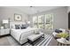 Main bedroom with three windows providing lots of light and decorative ceiling fan at 608 Kinship Ln, Apex, NC 27502