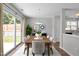 Bright dining room featuring sliding glass doors to the yard and a view of the kitchen at 608 Kinship Ln, Apex, NC 27502