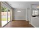 Bright dining area with sliding glass doors, wood floors, and an adjacent kitchen at 608 Kinship Ln, Apex, NC 27502