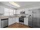 Updated kitchen with stainless steel appliances, granite countertops, and white cabinets at 608 Kinship Ln, Apex, NC 27502