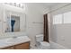 Functional bathroom with vanity, toilet, and tiled tub/shower with curtain at 6131 Summerpointe Pl # 101, Raleigh, NC 27606