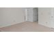 Bedroom with neutral carpet and multiple doors and closets providing ample storage at 6131 Summerpointe Pl # 101, Raleigh, NC 27606