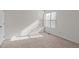 Bright bedroom with neutral carpet, window with blinds, and neutral paint at 6131 Summerpointe Pl # 101, Raleigh, NC 27606