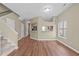 Elegant dining area with a glass-top table set on a patterned rug, adjacent to the kitchen and staircase at 6131 Summerpointe Pl # 101, Raleigh, NC 27606