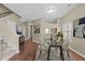 Elegant dining area with a glass-top table set on a patterned rug, adjacent to the kitchen and staircase at 6131 Summerpointe Pl # 101, Raleigh, NC 27606