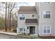 Two-story condo featuring neutral siding, a brown roof, and a covered front entrance with visible unit number at 6131 Summerpointe Pl # 101, Raleigh, NC 27606