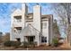 Exterior view of townhome featuring multiple balconies and meticulous landscaping at 6131 Summerpointe Pl # 101, Raleigh, NC 27606