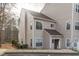 Exterior view of a two-story condo, highlighting its neutral siding, and visible unit number above the entrance at 6131 Summerpointe Pl # 101, Raleigh, NC 27606