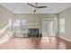 Living room featuring a fireplace, ceiling fan, and sliding glass doors to the outdoor space at 6131 Summerpointe Pl # 101, Raleigh, NC 27606