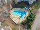 Aerial view of the community pool featuring meticulous landscaping and fencing at 6131 Summerpointe Pl # 101, Raleigh, NC 27606