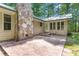 Back patio with stone fireplace and chair is perfect for outdoor relaxation and entertaining at 7849 Circle L Trl, Rougemont, NC 27572