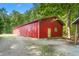 Large red barn with clean lines and gravel driveway, provides ample space and easy access at 7849 Circle L Trl, Rougemont, NC 27572