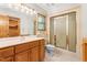 Well-lit bathroom features a shower with sliding glass doors and a vanity with ample counter space at 7849 Circle L Trl, Rougemont, NC 27572