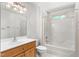 Bathroom with wood vanity, white sink, tiled shower and floors, and window for natural light at 7849 Circle L Trl, Rougemont, NC 27572