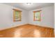 Bright bedroom with wood floors and trim, showcasing two windows offering natural light at 7849 Circle L Trl, Rougemont, NC 27572