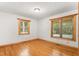 Bedroom boasts natural light from two large windows and classic hardwood flooring at 7849 Circle L Trl, Rougemont, NC 27572