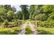 Long driveway extending to a rustic bridge at 7849 Circle L Trl, Rougemont, NC 27572