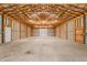 Spacious garage with unfinished walls, concrete floors, high ceilings, and an oversized garage door at 7849 Circle L Trl, Rougemont, NC 27572