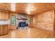 Living room area with wood ceiling, fireplace, and hardwood floors at 7849 Circle L Trl, Rougemont, NC 27572