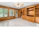 Living room with wood walls, built in cabinets, tile floors, and windows at 7849 Circle L Trl, Rougemont, NC 27572