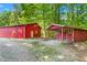 Multiple red outbuildings and sheds offer versatile spaces for storage and hobbies at 7849 Circle L Trl, Rougemont, NC 27572