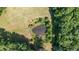 An aerial view showcases a small pond and surrounding lush greenery, creating a peaceful retreat at 7849 Circle L Trl, Rougemont, NC 27572