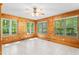 Sun room with wood walls, tile floors, and windows at 7849 Circle L Trl, Rougemont, NC 27572