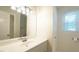 Bright bathroom featuring a white vanity, mirror, and a shower/tub with neutral wall paint at 8201 Blue Heron Way, Raleigh, NC 27615