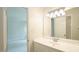 Bathroom vanity featuring a white vanity, mirror, with a view into the hallway with neutral wall paint at 8201 Blue Heron Way, Raleigh, NC 27615