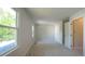 Bedroom features neutral carpeting, two windows, and views into an adjoining room at 8201 Blue Heron Way, Raleigh, NC 27615
