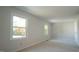 Bedroom with two windows offering abundant natural light, and neutral carpeting at 8201 Blue Heron Way, Raleigh, NC 27615