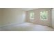 Bright bedroom with neutral walls and carpet, two windows at 8201 Blue Heron Way, Raleigh, NC 27615