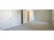 Bedroom with neutral carpeting, walk-in closets, and views into an adjoining room at 8201 Blue Heron Way, Raleigh, NC 27615