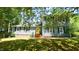 Attractive two-story home with a bright yellow front door and well-manicured lawn at 8201 Blue Heron Way, Raleigh, NC 27615