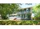 Charming two-story home with black shutters and brick accents, nestled under lush green trees at 8201 Blue Heron Way, Raleigh, NC 27615