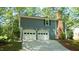 Home featuring a two-car garage and brick chimney at 8201 Blue Heron Way, Raleigh, NC 27615
