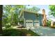 Exterior view showcasing a classic two-story home with an attached two-car garage and a brick chimney at 8201 Blue Heron Way, Raleigh, NC 27615