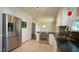 Open kitchen with stainless steel appliances, tile floors, and ample cabinet space at 8201 Blue Heron Way, Raleigh, NC 27615